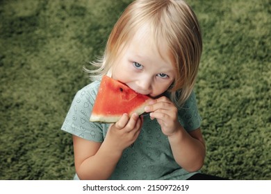 Funny Little Girl Eating Watermelon Close-up. Cute Child With Watermelon Indoors. Concept Of Healthy Food, Summertime. Copy Space