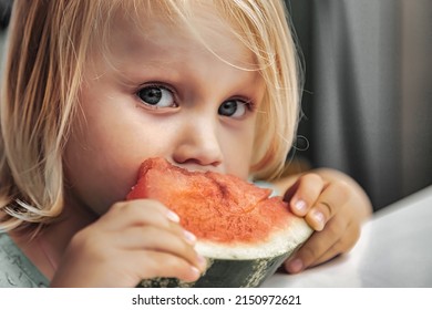 Funny Little Girl Eating Watermelon Close-up. Cute Child With Watermelon Indoors. Concept Of Healthy Food, Summertime. Copy Space