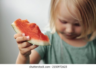 Funny Little Girl Eating Watermelon Close-up. Cute Child With Watermelon Indoors. Concept Of Healthy Food, Summertime. Copy Space