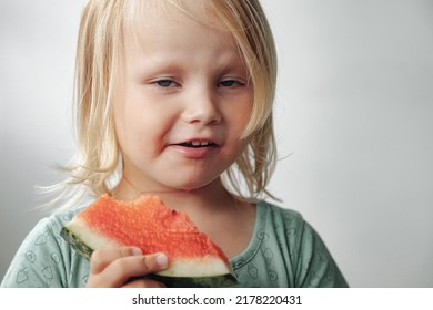 Funny Little Girl Eating Watermelon Close-up. Cute Child With Watermelon Indoors. Concept Of Healthy Food, Summertime. Copy Space