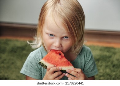 Funny Little Girl Eating Watermelon Close-up. Cute Child With Watermelon Indoors. Concept Of Healthy Food, Summertime. Copy Space