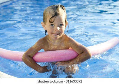 Funny Little Girl Learning To Swim With Pool Noodle