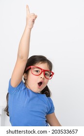 funny little girl lifting hand up. small girl shouting and wearing glasses