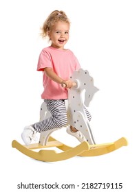 Funny little girl with rocking horse on white background