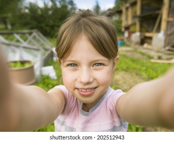 Funny Little Girl Taking Selfie Outdoors.