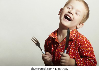 Funny Little Handsome Boy With Fork And Knife. Hungry Child. Smiling Kid. Want To Eat