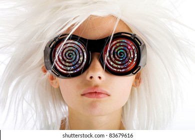 A funny looking kid with crazy white hair and wild hypnotic glasses.