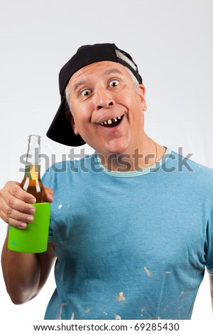 Funny looking middle age man with bad teeth holding a beer bottle and wearing a baseball cap.