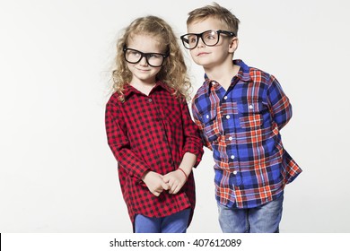 Funny lovely children.  fashionable little boy and girl in glasses, jeans, white t-shirts and plaid shirts.stylish kids in casual shoes. fashion children