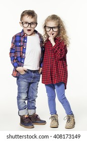 Funny Lovely Children.  Fashionable Little Boy And Girl In Glasses, Jeans, White T-shirts And Plaid Shirts. Stylish Kids In Casual Clothes In Shocked. Fashion Children