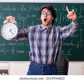Funny male math teacher in the classroom