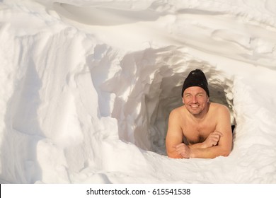 Funny Man With Bare Torso Looks Out Of Snow Cave, Winter Morning, Siberian Tourist, Winter Holiday Outdoor 