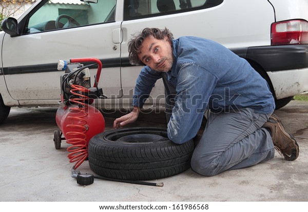 funny man and car spare\
tire
