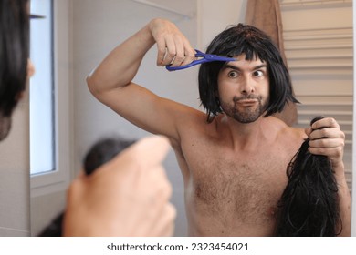 Funny man cutting his own hair 