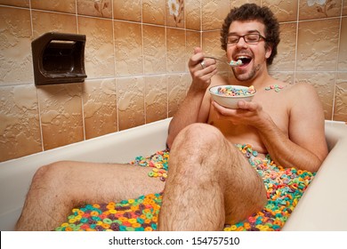 Funny man eating his cereals in the bathtub