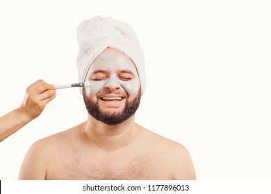 A funny man in a face mask in a beauty salon.