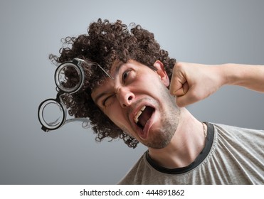 Funny man is getting punch in face with fist. - Shutterstock ID 444891862
