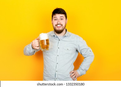 Funny Man With A Glass Of Beer And Foam On His Mustache And Nose On A Yellow Background