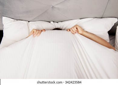 Funny Man Hiding In Bed Under The Sheets.