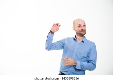 Funny Man On A White Background.
Businessman Humorist In A Blue Shirt. Bald Man Shows His Hand