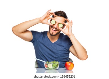 Funny Man Playing With Cucumber On Eyes, Havind Healthy Food In Front