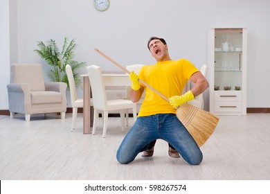 Funny man playing virtual guitar with broom