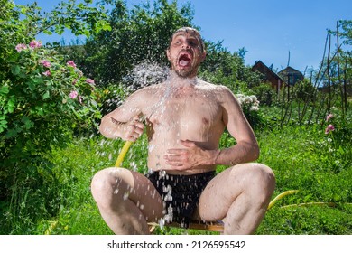 Funny man pours water on a hot day.