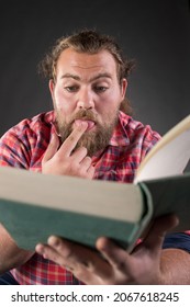 Funny man reading book, very interested in subject