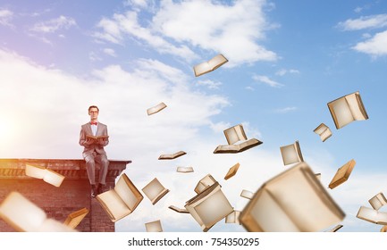 Funny man in red glasses and suit sitting on top and reading book - Shutterstock ID 754350295