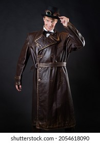 Funny Man In A Ridiculous Leather Coat And A Top Hat, Vintage Style Of Clothing, Photo On A Black Background