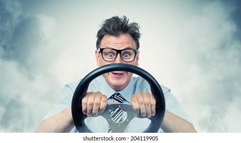 Funny man with a steering wheel in smoke