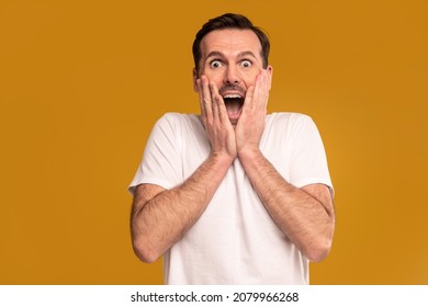 Funny Man With Surprised Emotions On His Face Looking At The Camera. A Lot Of Copy Space. Facial Expressions Concept. Real People. Studio Shot.