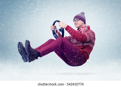 Funny Man In Sweater, Scarf And Hat, Driving Car With The Steering Wheel. Winter, Snow, Blizzard