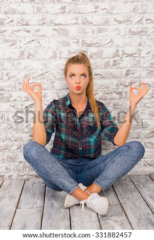 Funny meditating  girl sitting on the floor