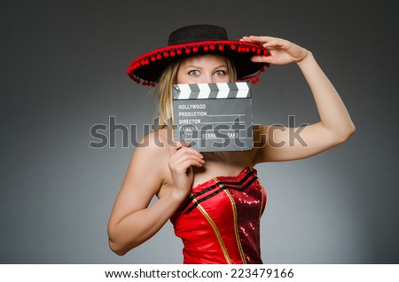 Funny mexican woman with sombrero and movie clapboard