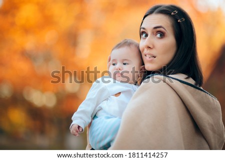 Funny Mom Holding Her Adorable Baby Girl. Expressive portrait of a mother and newborn daughter bonding
