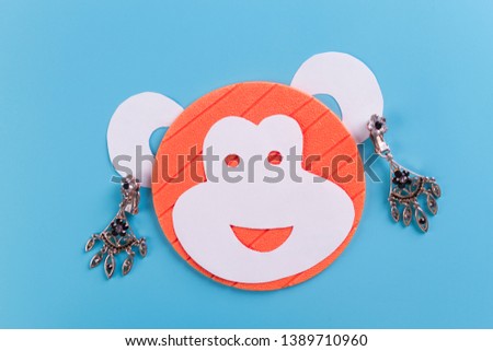 funny monkey made of paper blue background