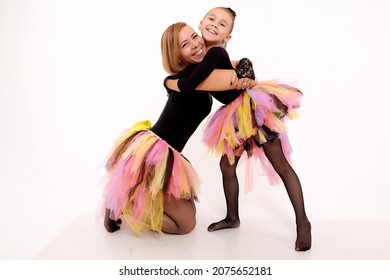 Funny Mother And Daughter In Same Outfits Posing On Studio Weared Tutu Skirts On The White Background