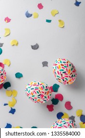 Funny Multicolored Easter Eggs Hand Painted And Splash Of Colorful Papers In Movement From Above. Easter Background. No People