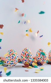 Funny Multicolored Easter Eggs Hand Painted And Splash Of Colorful Papers In Movement. Easter Background. No People