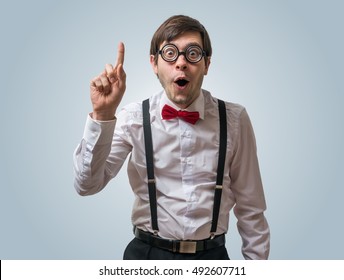Funny nerd or geek have an idea and holds finger up. - Shutterstock ID 492607711