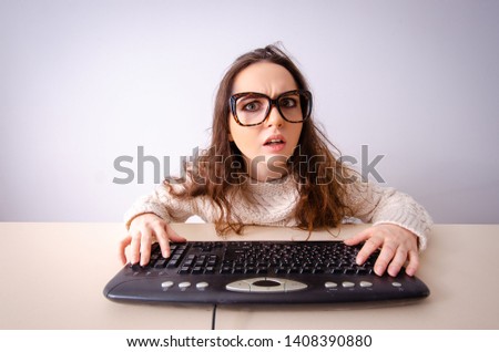 Funny nerd girl working on computer
