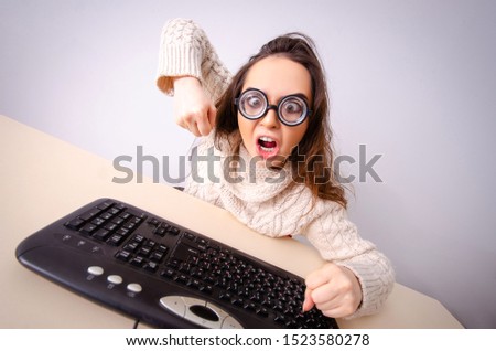 Funny nerd girl working on computer