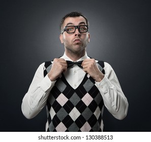 Funny nerd preparing to go out for a date isolated over dark gray textured background