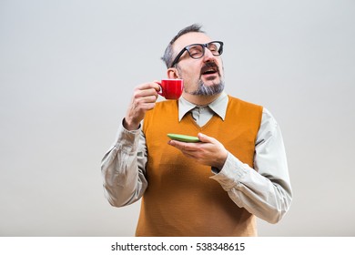 Funny nerdy man enjoys drinking coffee.Nerdy man drinking coffee
 - Powered by Shutterstock