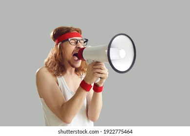 Funny Noisy Crazy Nerdy Young Man In Retro Sportswear Standing Isolated On Gray Background, Yelling In Megaphone, Announcing Important Marketing Message, Advertising Gym Workout Equipment Sale