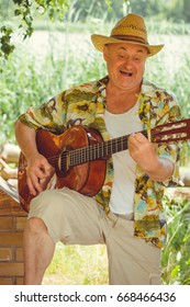 Funny Older Man In Print Shirt Tourist Playing Guitar And Sing Song On Nature Outdoors, Trip To America And Pleasure For Vacation