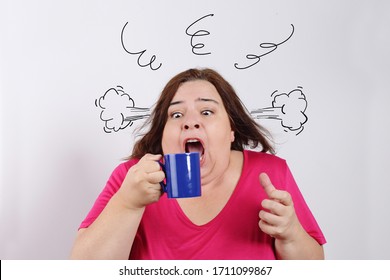 
Funny Overweight Caucasian Brunette Woman Drinking Too Strong And Too Hot Coffee With Humorous Smoke Drawing On Studio Isolated White Background