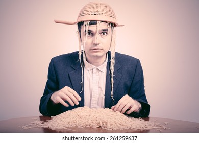 Funny Pastafarian with colander and pasta.
