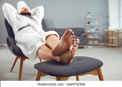 Funny Pedicure Concept. Funny Fat Man In A Bathrobe And A Towel Paints His Nails